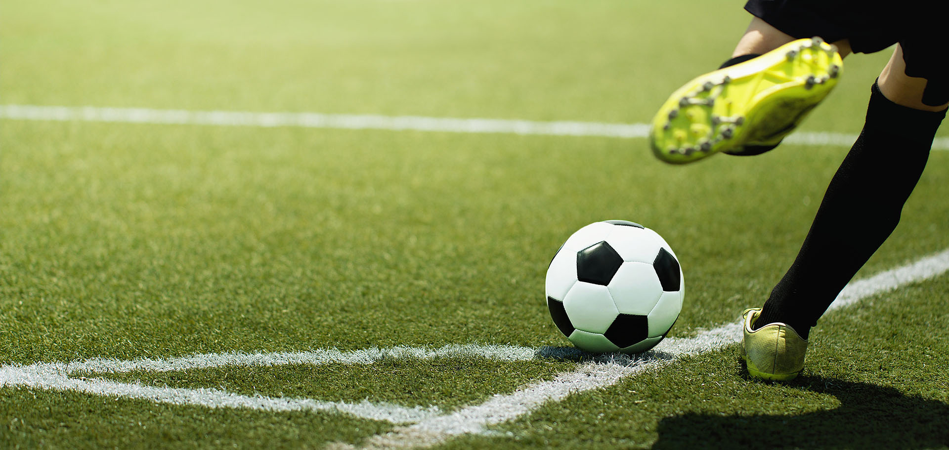 Man playing soccer on artificial turf