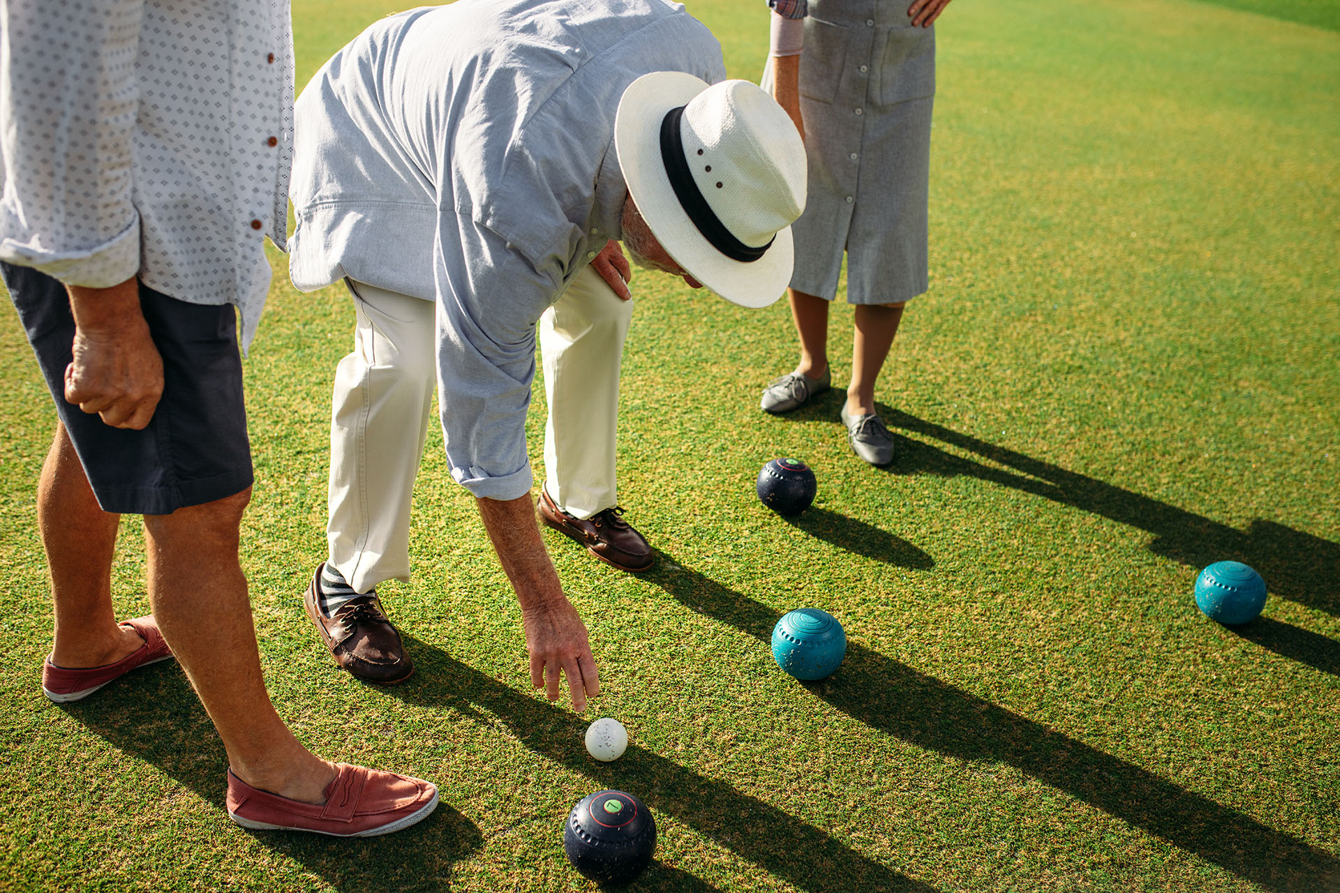 Senior people playing bocce ball in a park