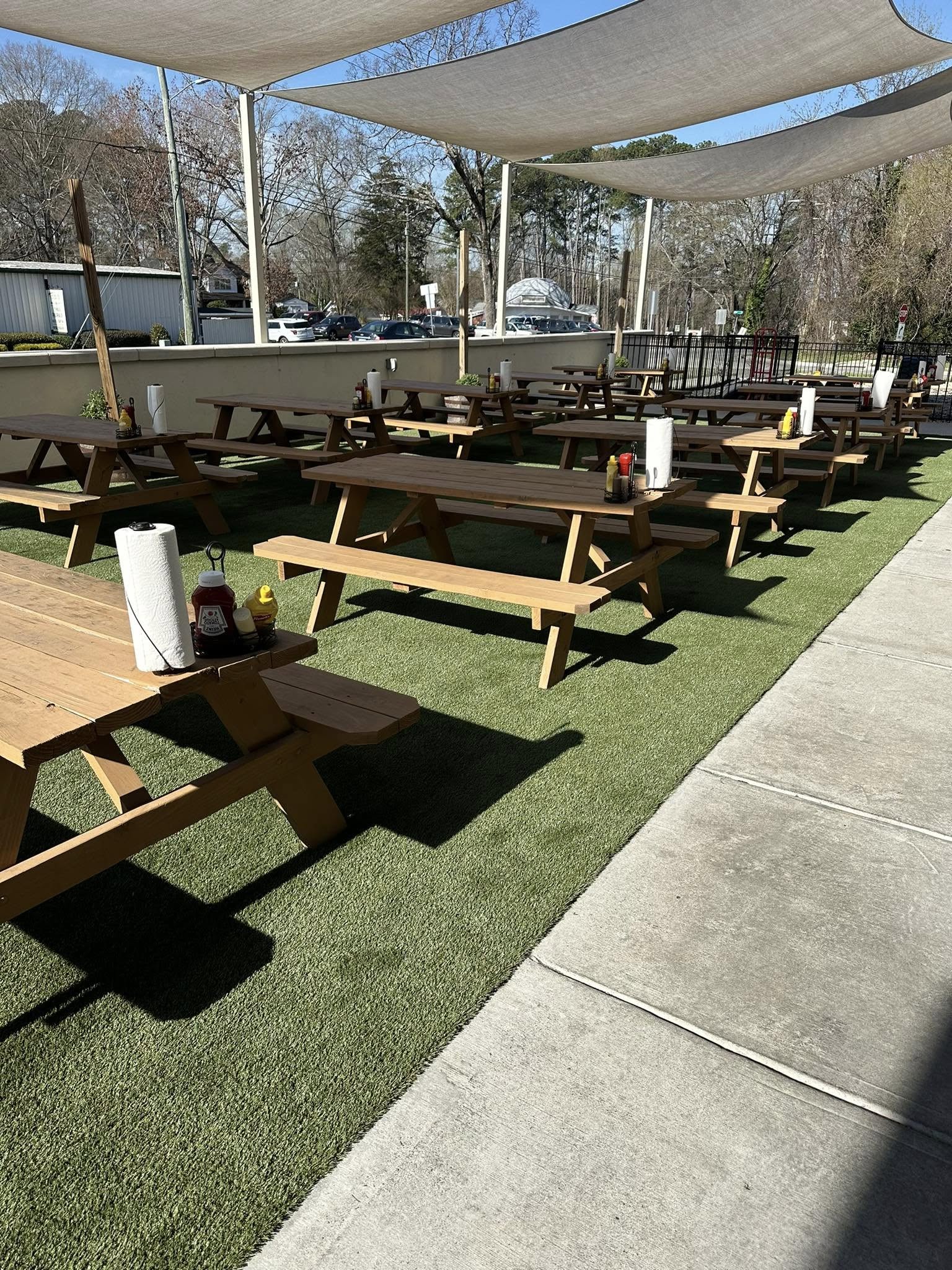 fake grass in the outdoor picnic area of a restaurant