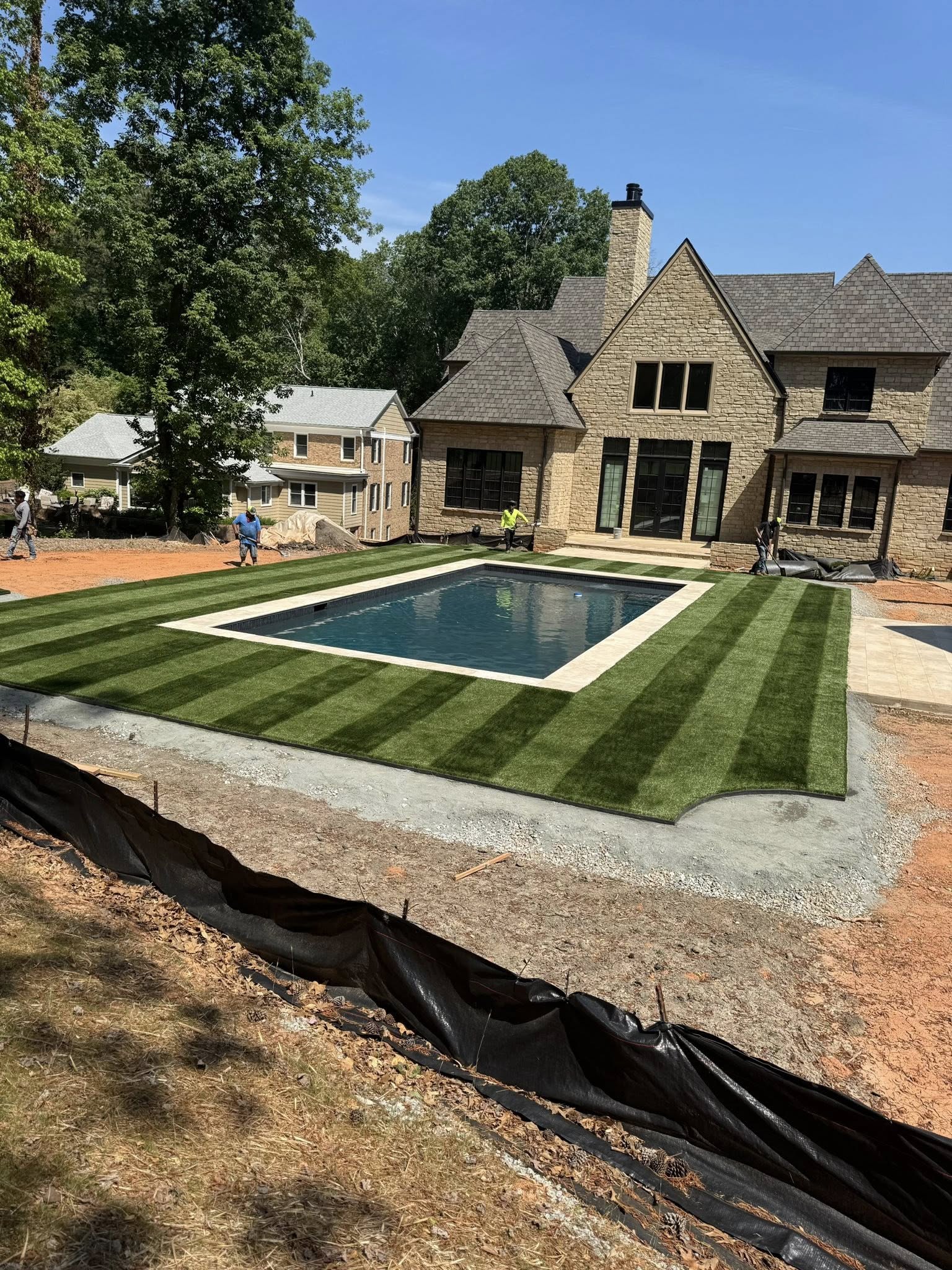 Artificial grass around in-ground pool