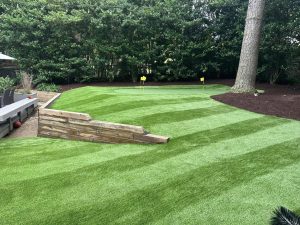 Artificial grass and short stone retaining wall