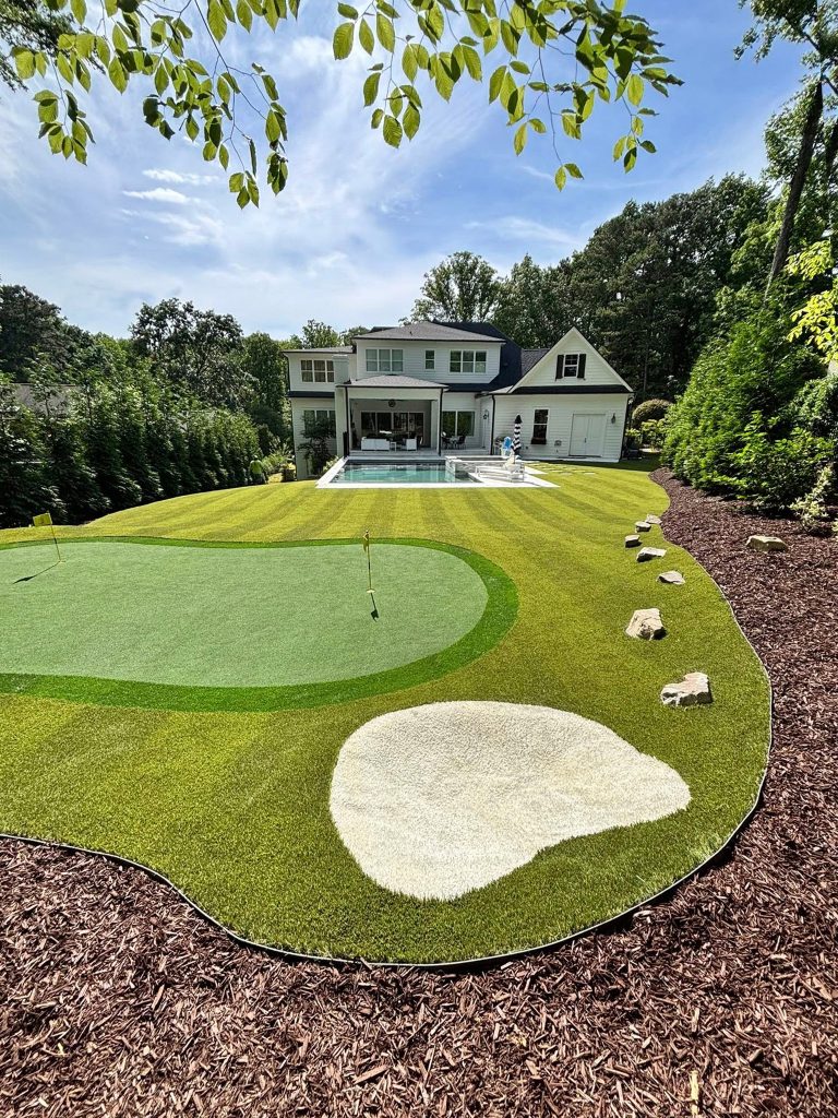 backyard putting green and artificial turf around pool